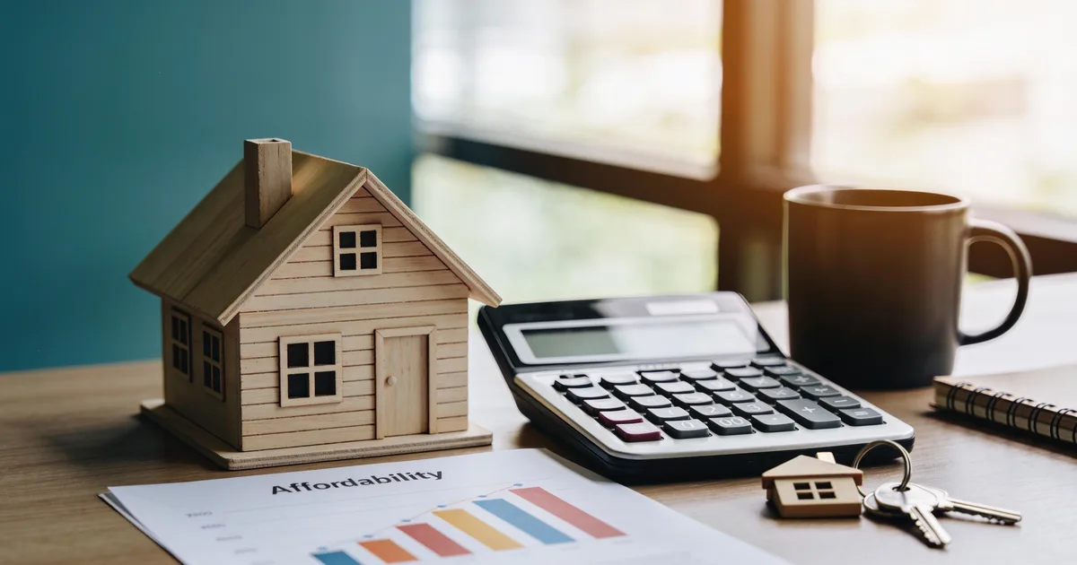 How much house can I afford: a model house beside a calculator and a salary-to-price affordability chart